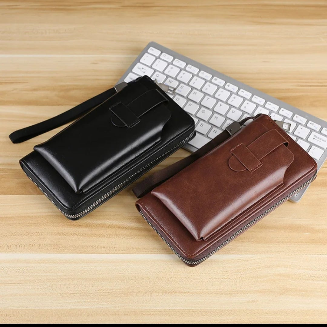 Two leather wallets, one black and one brown, on a wooden surface with a keyboard.