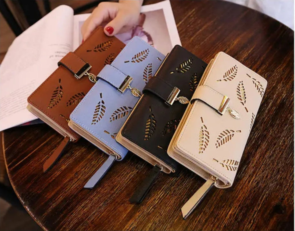 Set of four notebooks with different designs on a wooden surface