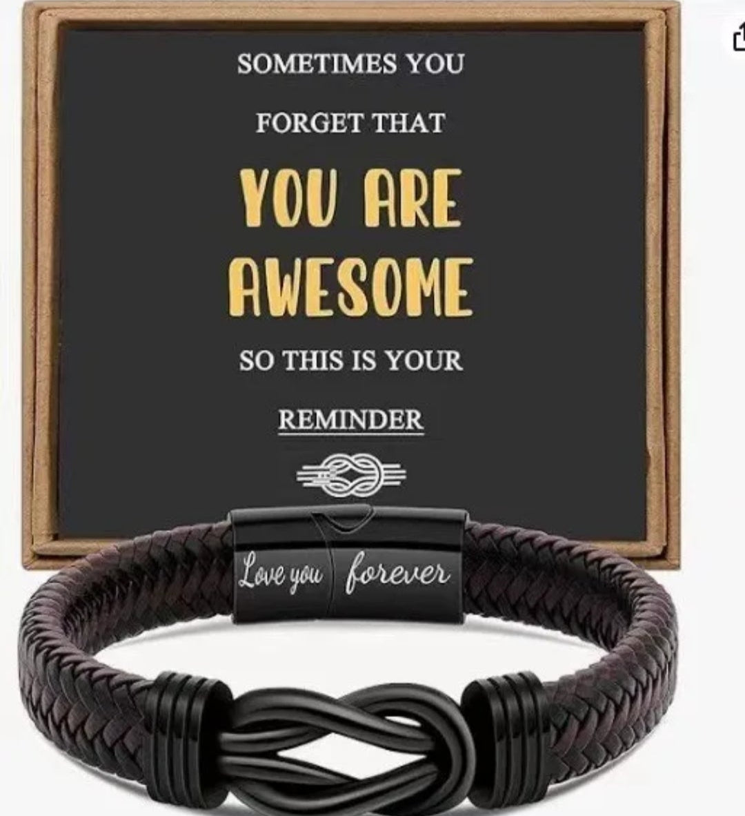 Black braided bracelet with a motivational quote card in the background