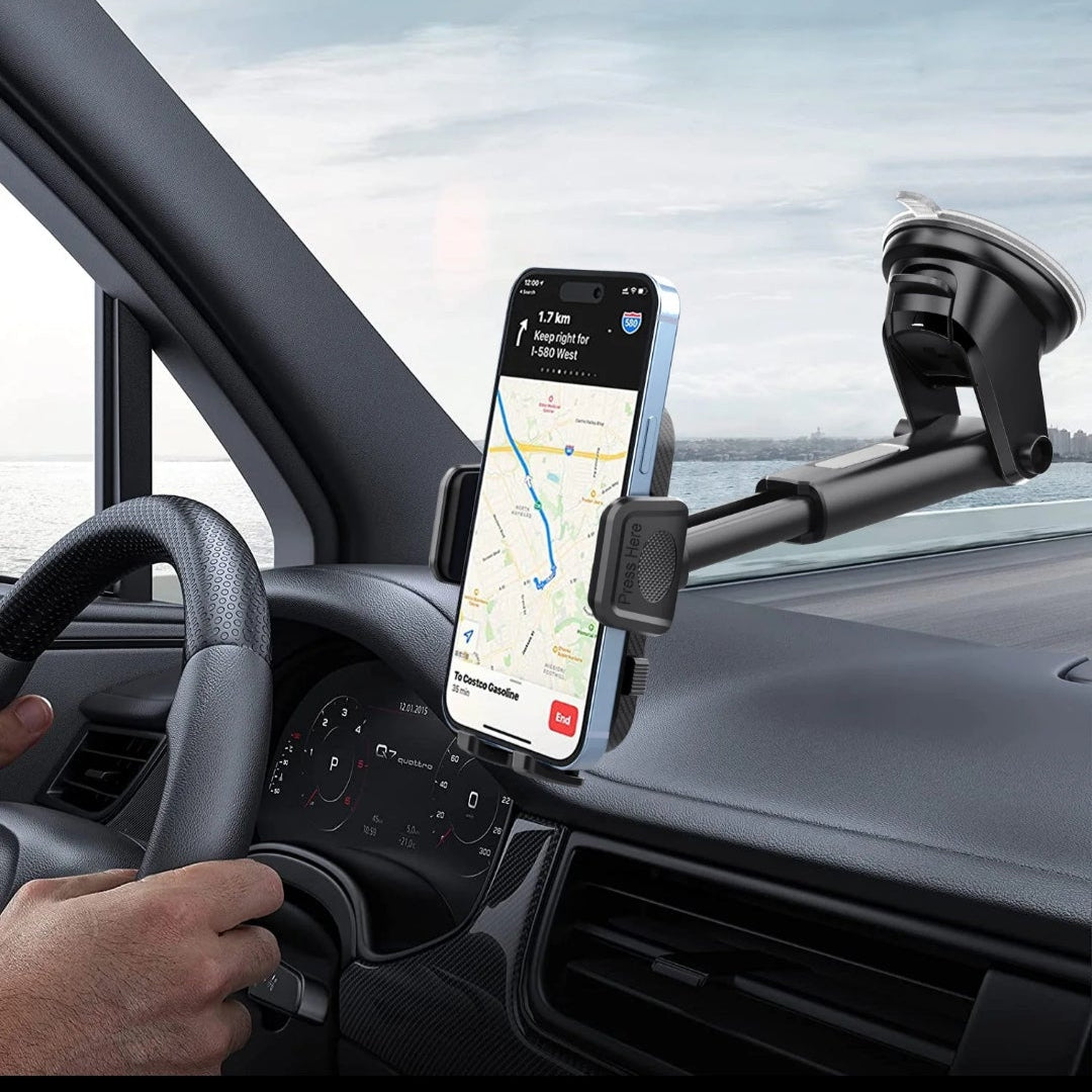 Phone mounted on a car dashboard with a navigation app displayed, inside a vehicle.