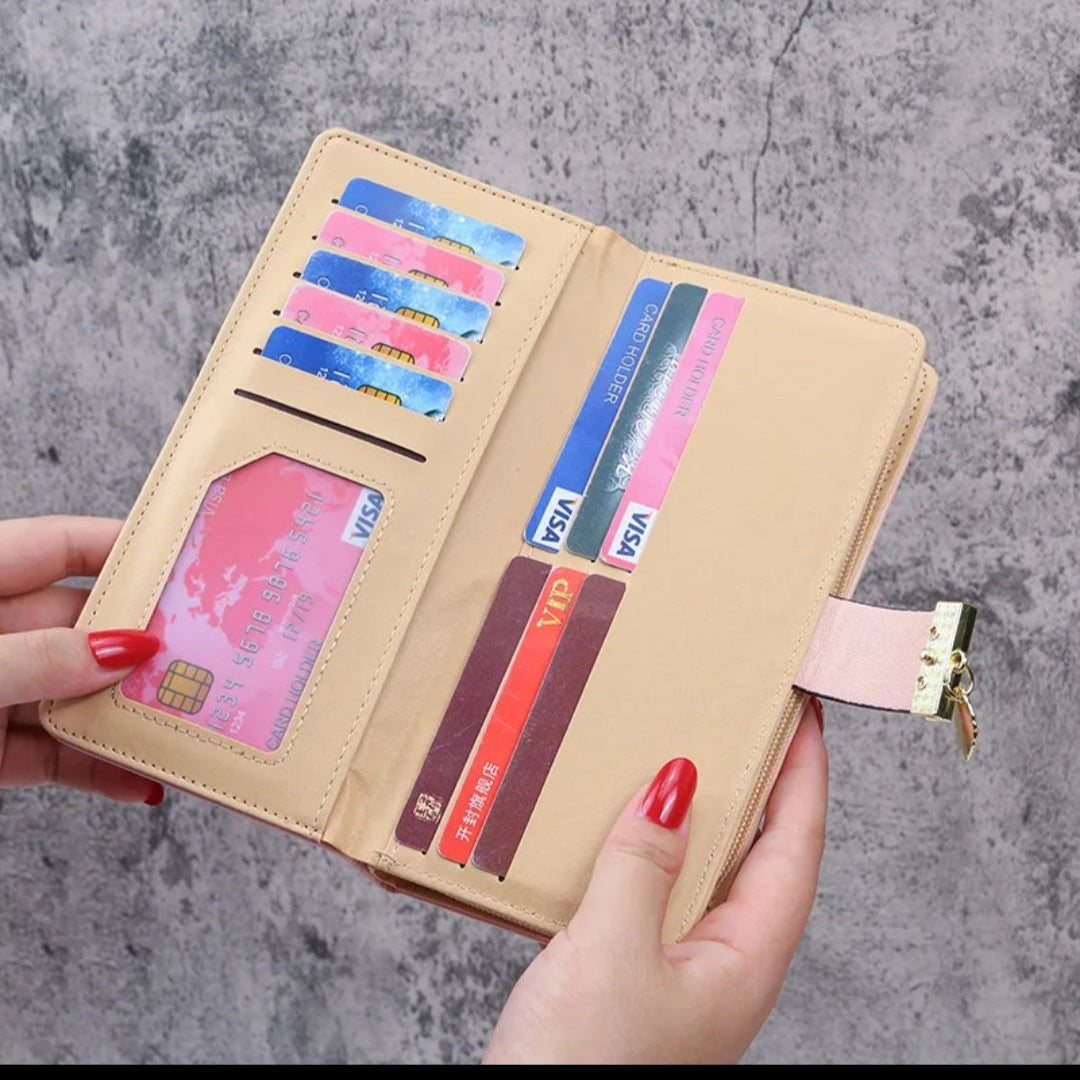 Hand holding a beige wallet with multiple cards against a gray background