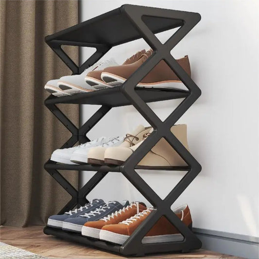 Black shoe rack with shoes on a wooden floor against a white wall.